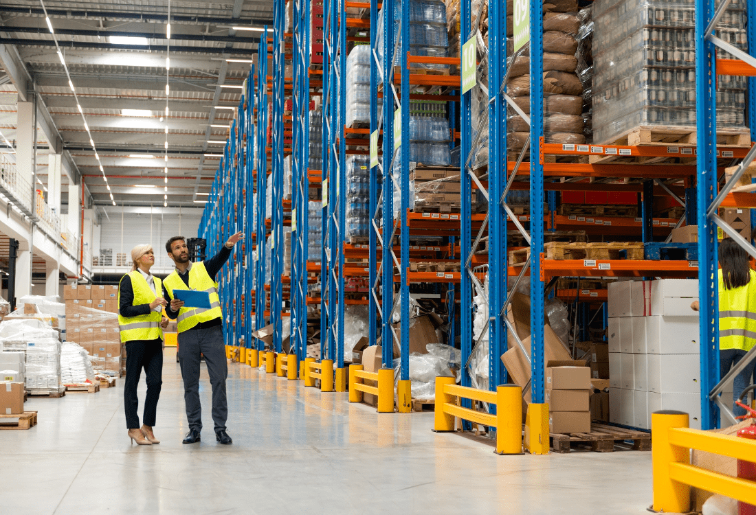 Two warehouse workers debating between implementing SaaS WMS and Server WMs.