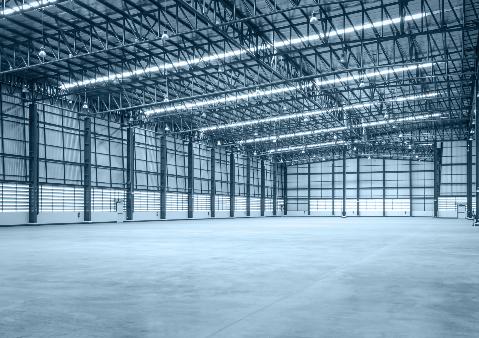 Large empty warehouse space with fitted lighting